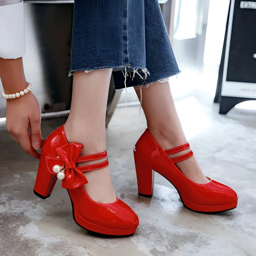 Women's red chunky heel platform shoes with round toe and buckle fastening on a rubber sole.