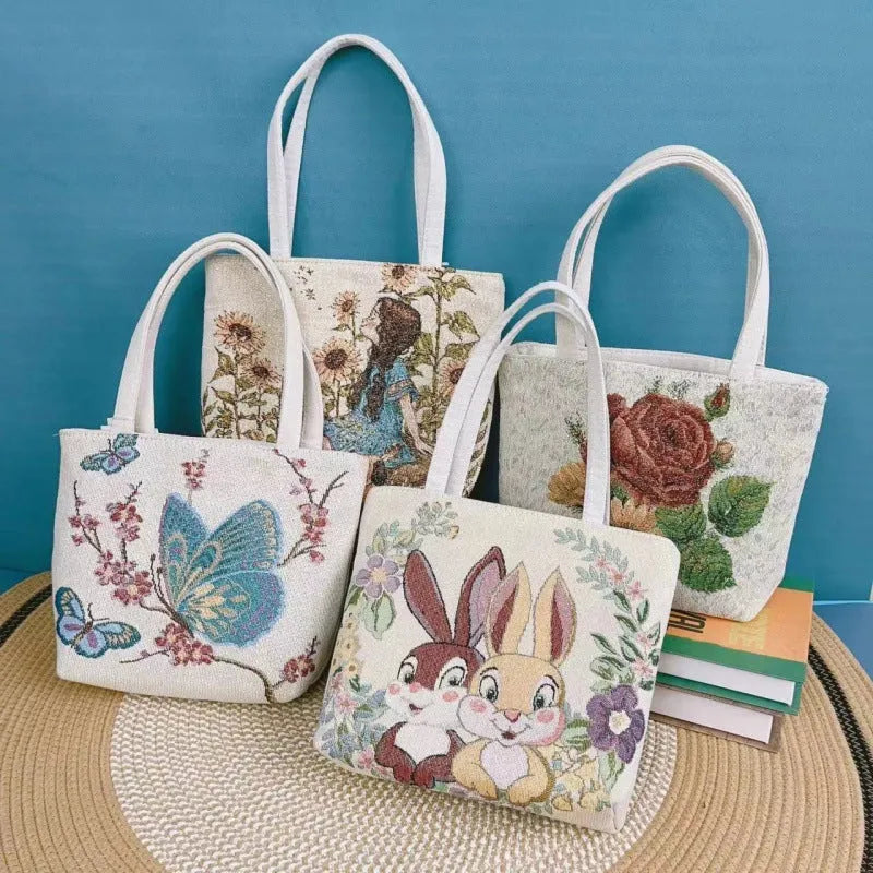 Double-sided gold wire embroidered canvas handheld bag in a floral design with polyester lining.