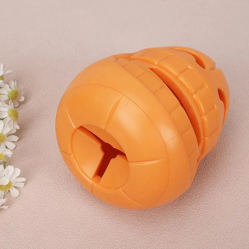 Yellow pumpkin-shaped tough TPR chew toy for dogs on a white background.