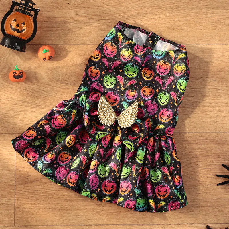 Dog wearing orange angel wings Halloween costume with bright pumpkin design.