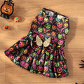 Dog wearing orange angel wings Halloween costume with bright pumpkin design.