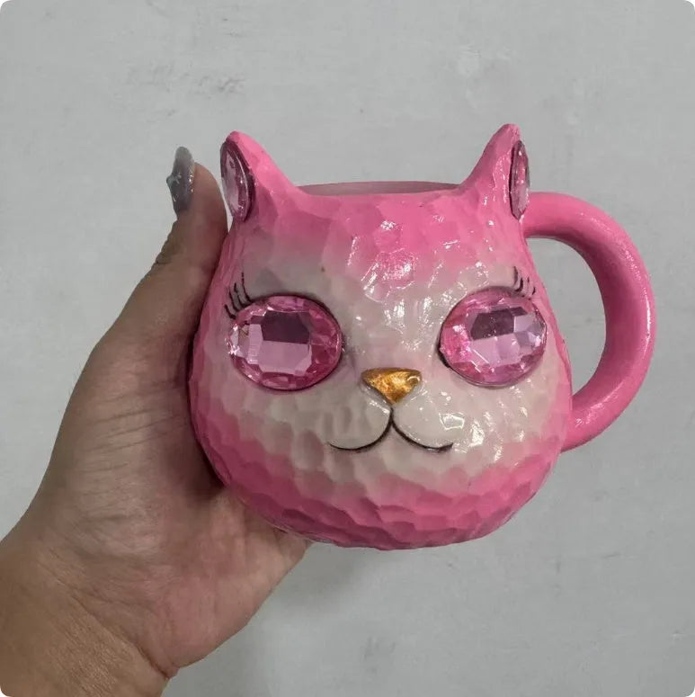 Clear resin Cat Cup ornament in purple, green, blue, and pink colour options on display.