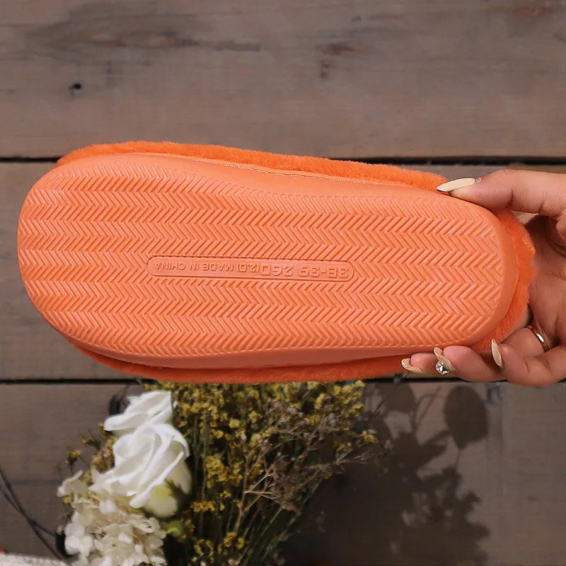Orange plush Halloween pumpkin slippers with a coral velvet upper and non-slip sole