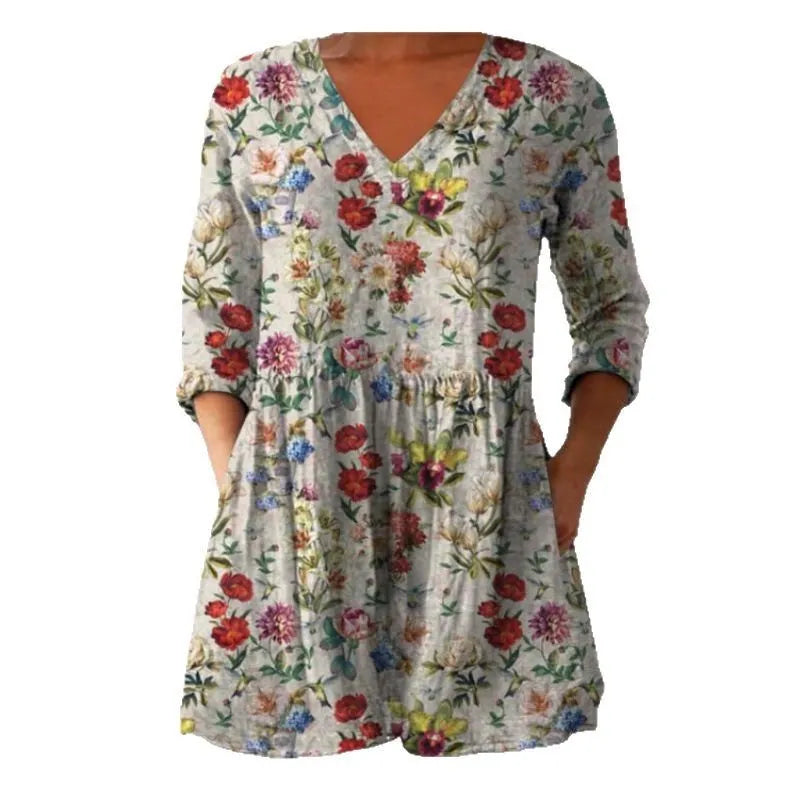 Women's loose-fitting long dress with a blue wave pattern print and 3/4 sleeves.