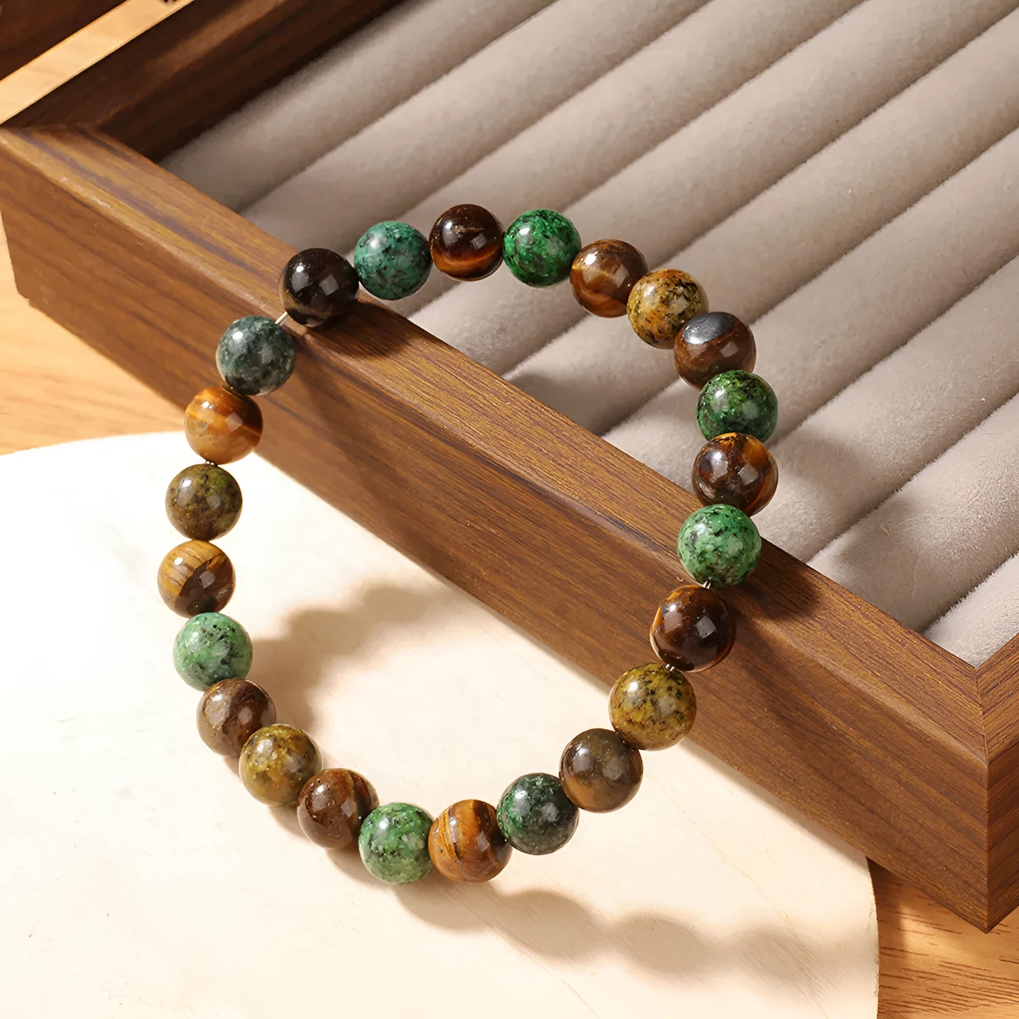 Handmade tigereye stone bracelet with 18mm flower-design beads on an adjustable strap.