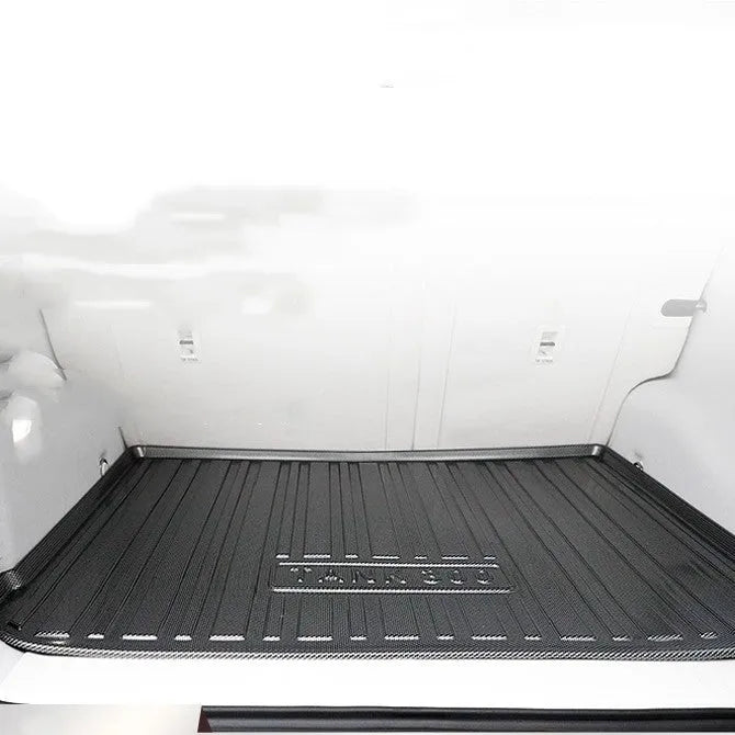 Black carbon fibre pattern TPE car boot liner mat for vehicle cargo protection.