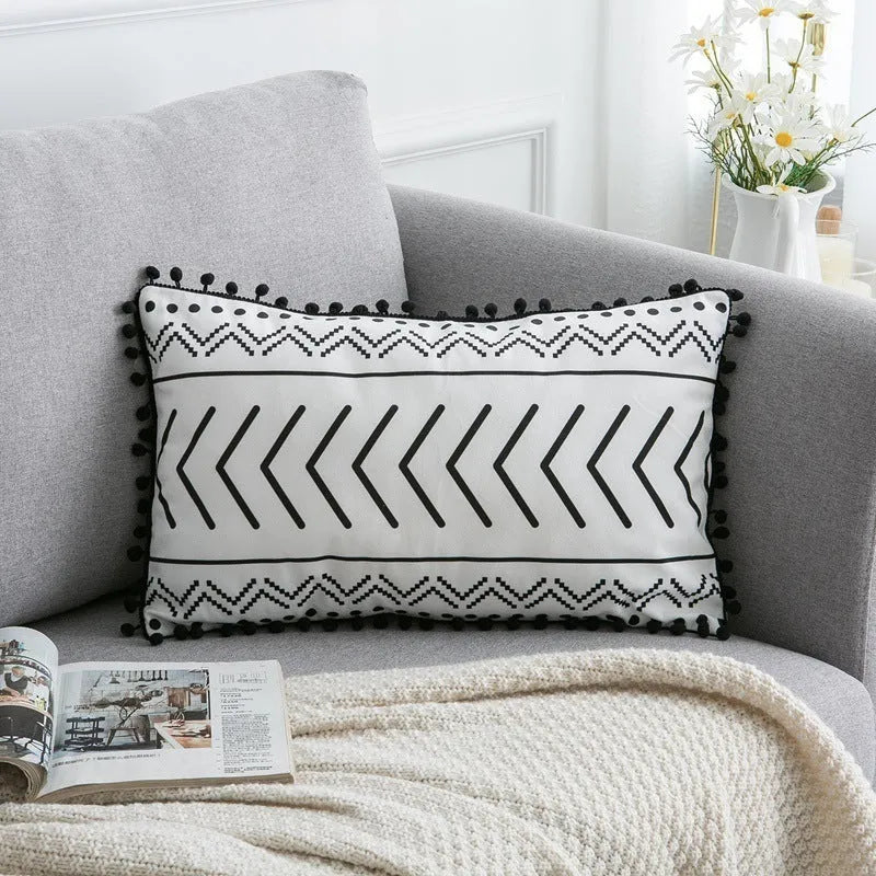 Bohemian national style throw pillow cushion cover in light grey on a sofa.