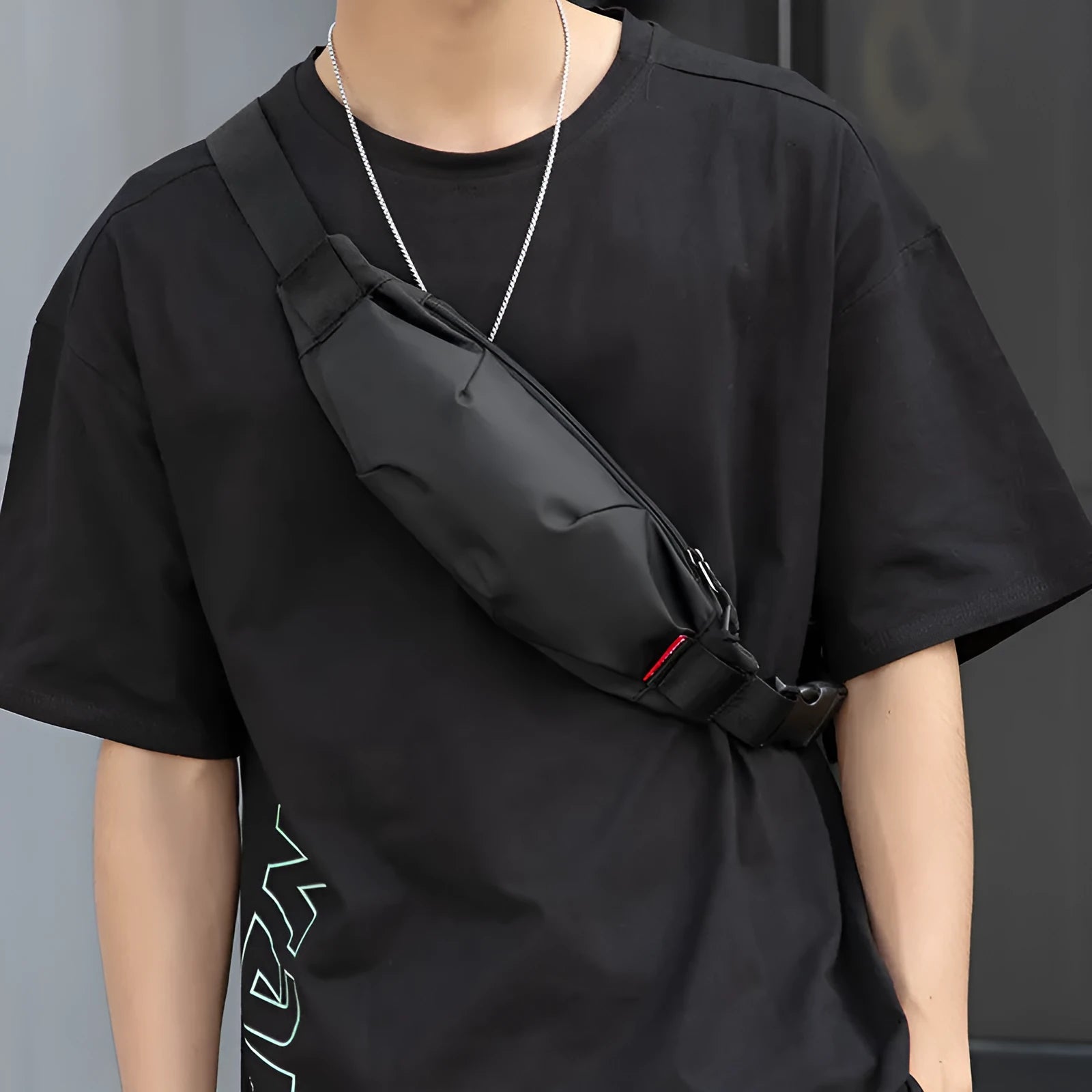 Black Oxford cloth men's crossbody waist pack showing front zipper and interior organisation pockets.