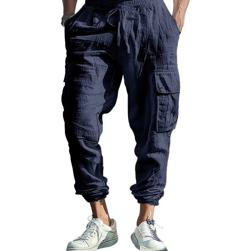 Men's solid colour linen casual trousers with ankle ties and multiple pockets in a loose fit.