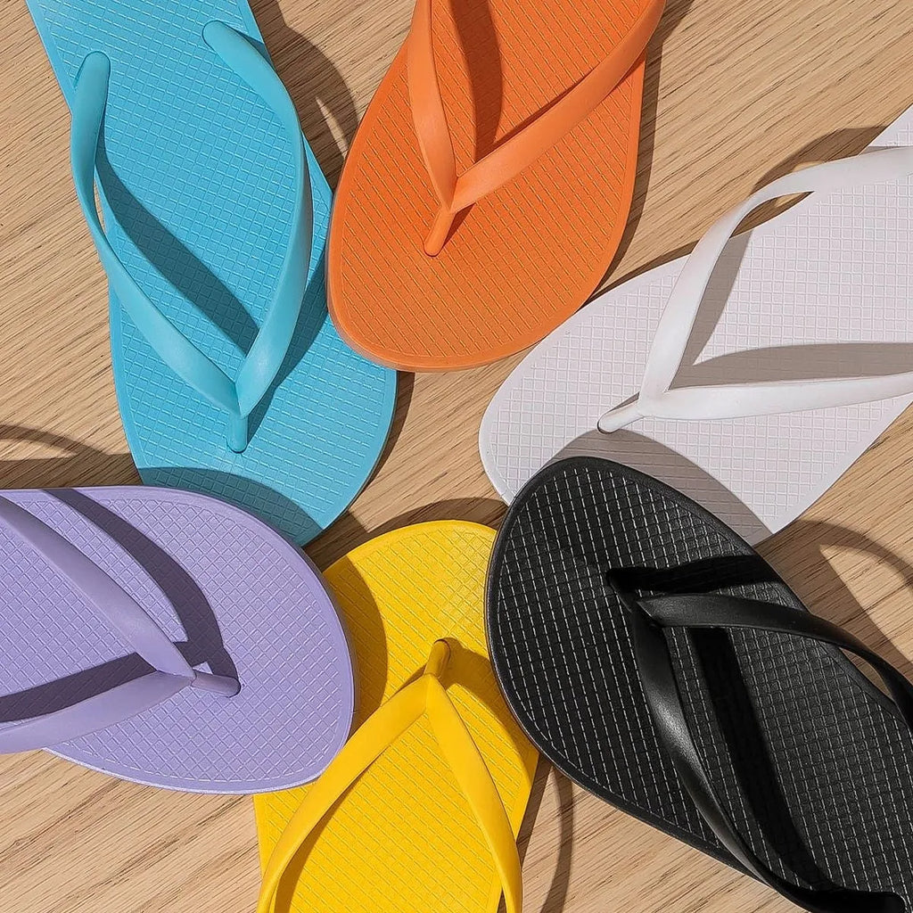 Foldable flat beach slippers with non-slip PVC sole and hollow out plastic upper in orange.