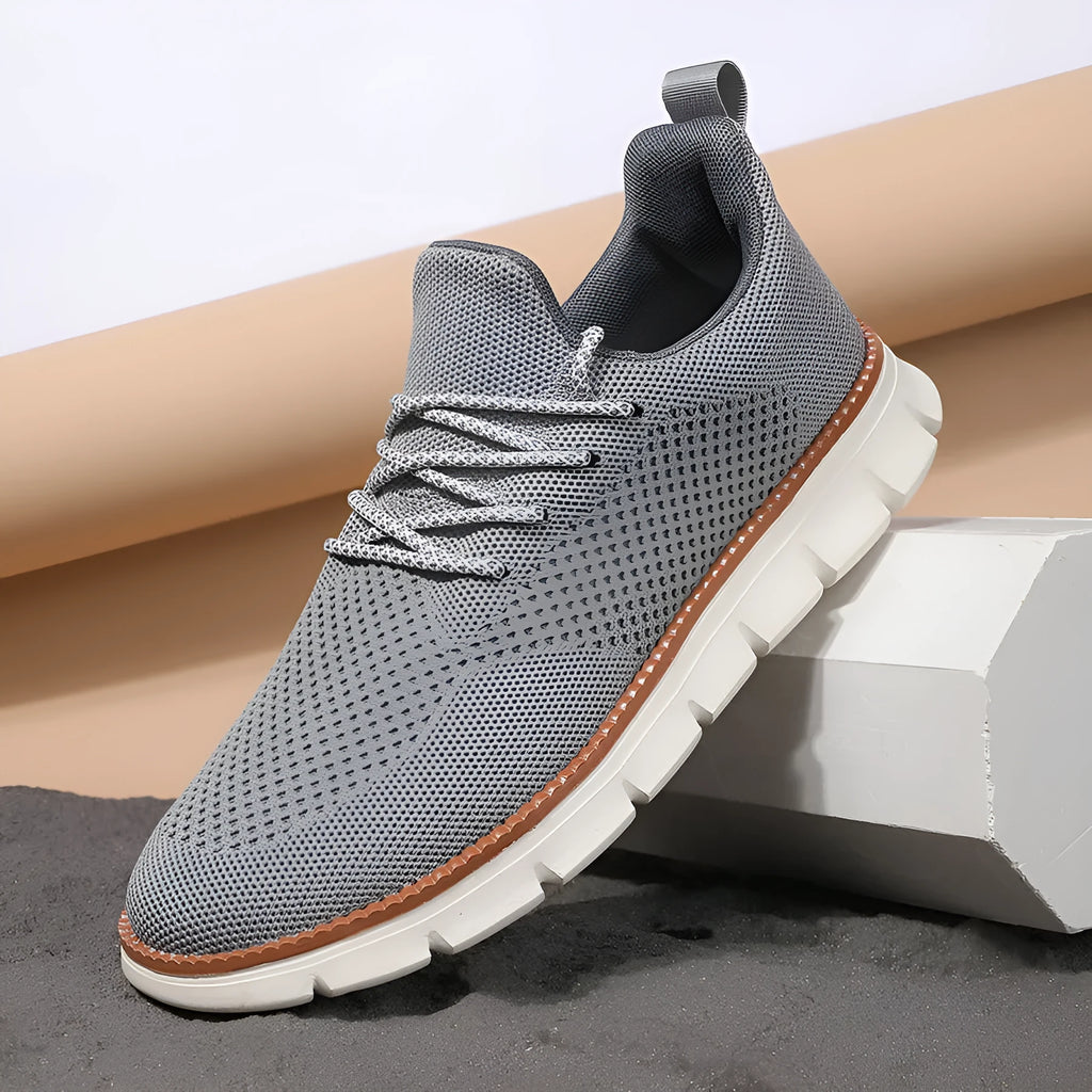 Men's grey and black casual sneakers with woven mesh upper and round toe.