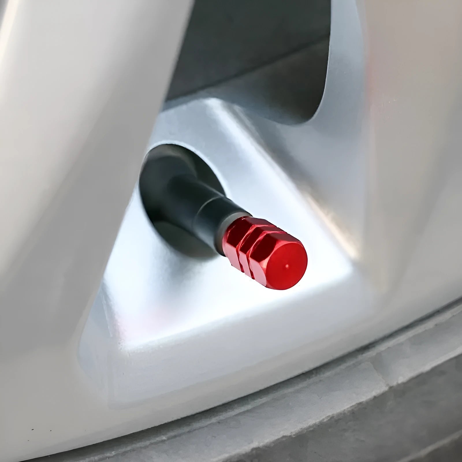 Set of ten aluminium alloy car valve caps in blue, red, silver, gold and black on a white background