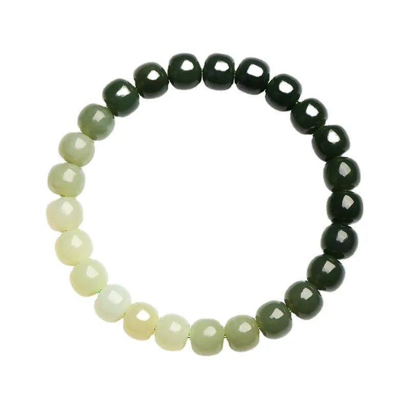 Natural Hetian jade bracelet with gradient clear water colours on a wrist, showing polished beads.