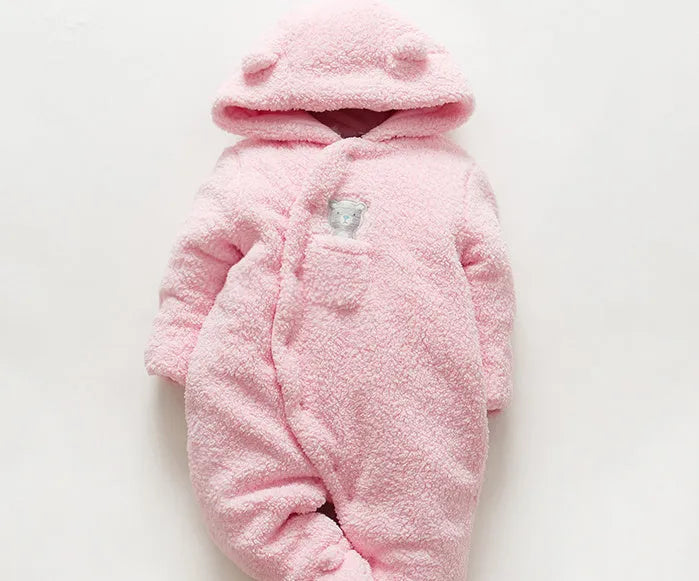 Baby wearing white cotton padded romper with lamb design and feet covers