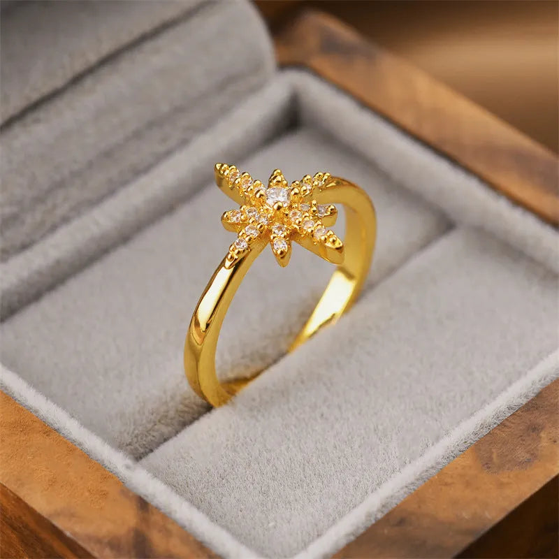 Gold geometric open fashion ring for women on a plain background