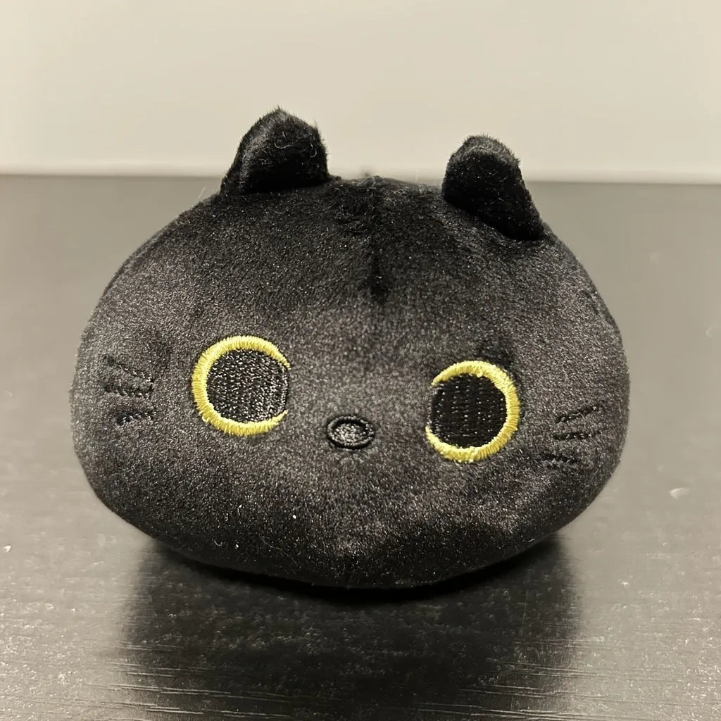Fluffy black cat plush toy stuffed animal pillow cushion on a neutral background