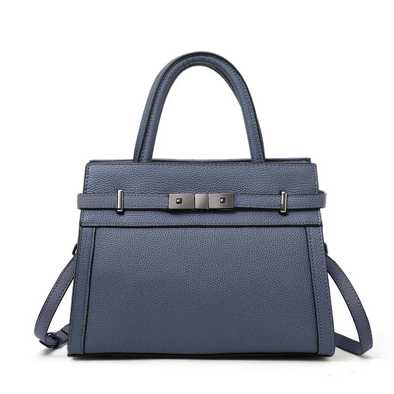 A structured square genuine leather women's crossbody bag in black, shown open to reveal internal organiser pockets.