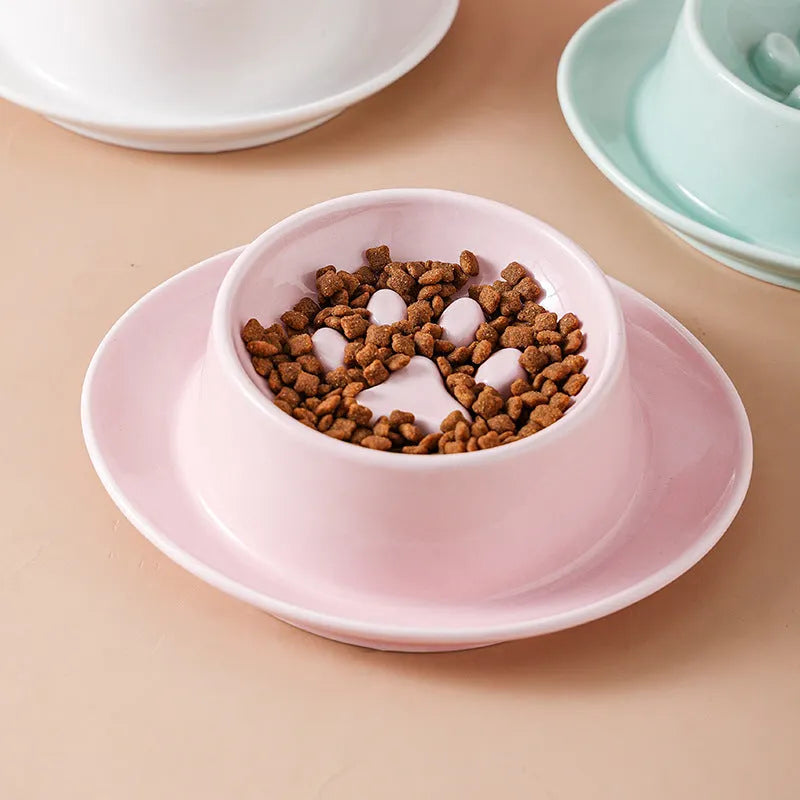 Green ceramic slow feeder pet bowl with central anti-choking basin on a white background.