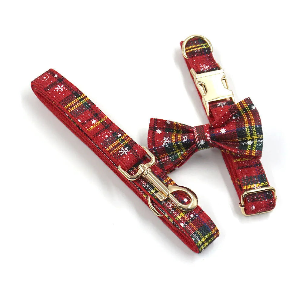 Red Christmas fabric pet collar set with matching harness, rope, bow, and waste bag