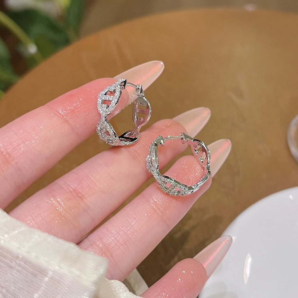 A pair of casual ladies earrings in thick gold plating with a diamond accent, shown in silver, gold, and rose gold colour options