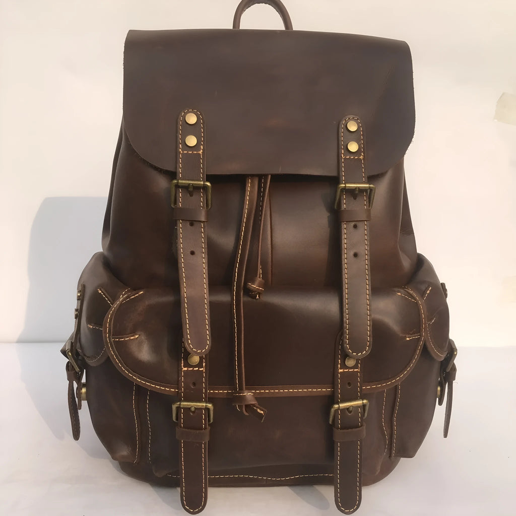 Brown men's leather backpack with an air-pillow belt system on the back.