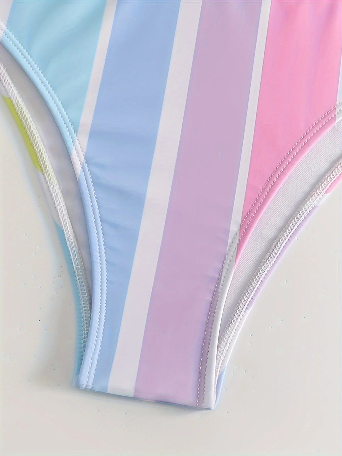 Striped women's bikini top and bottom set for sports swimming.