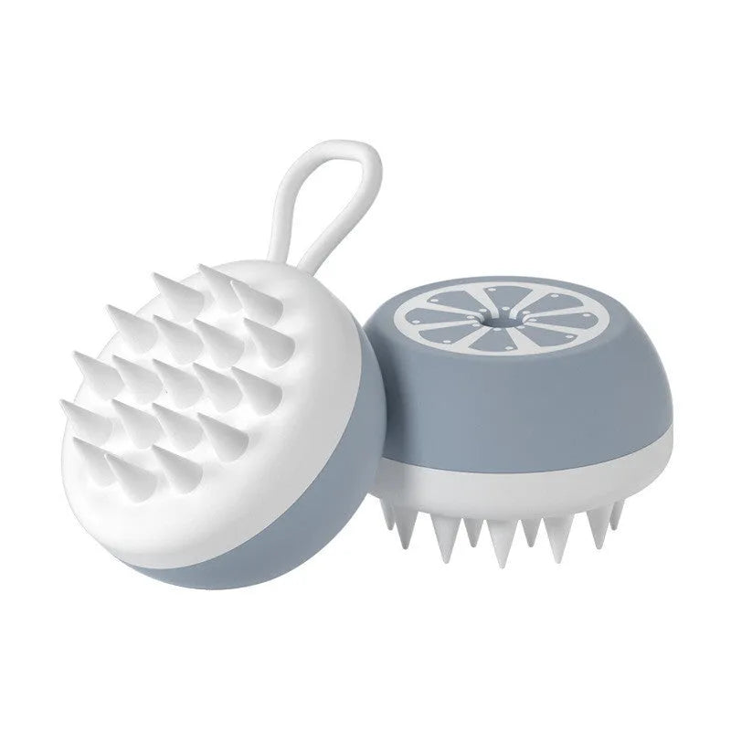 Yellow silicone pet bath brush with massage bristles next to a navy blue comb style brush on a bathroom surface.