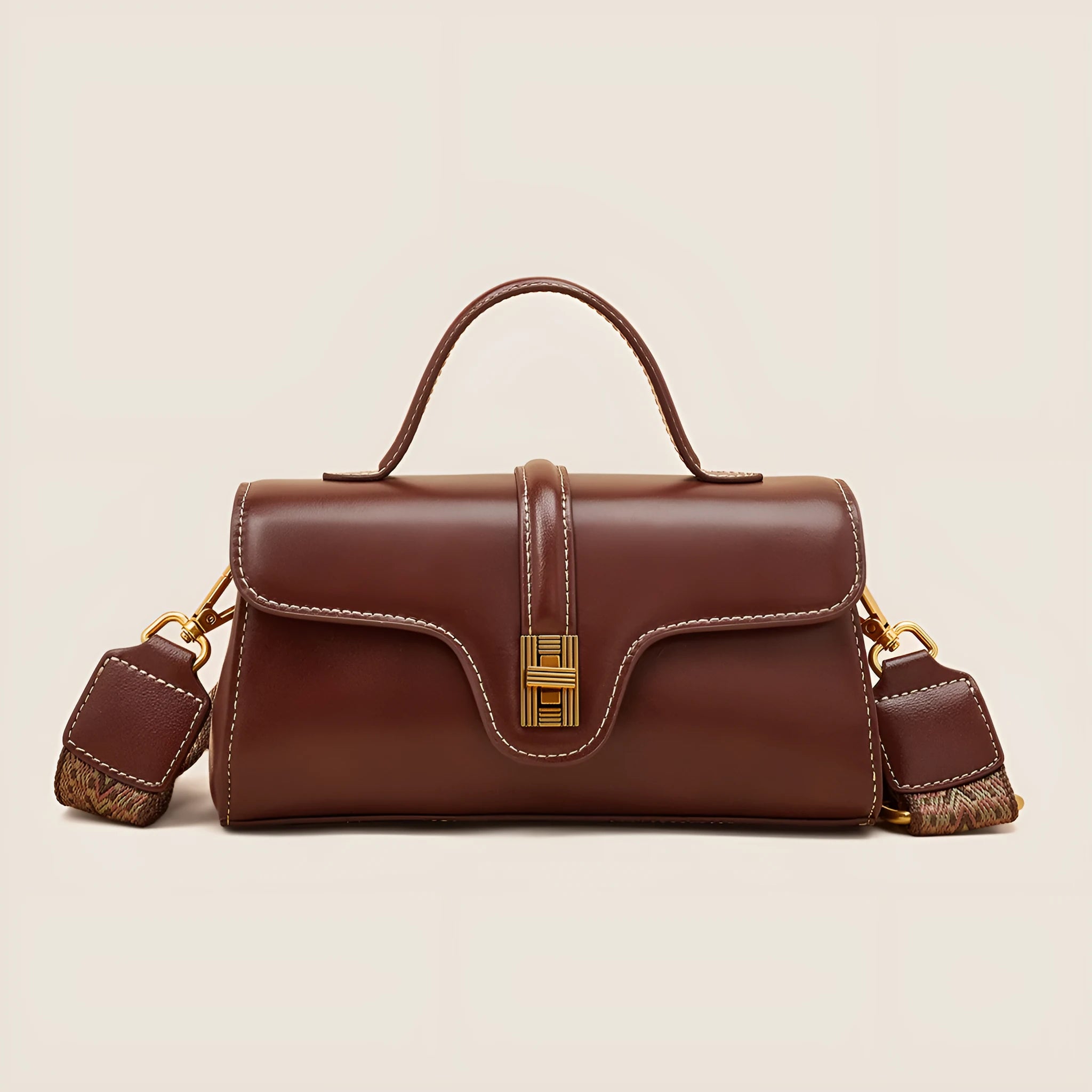 Cambridge-style leather messenger bag in clamshell design with lock detail and internal compartments