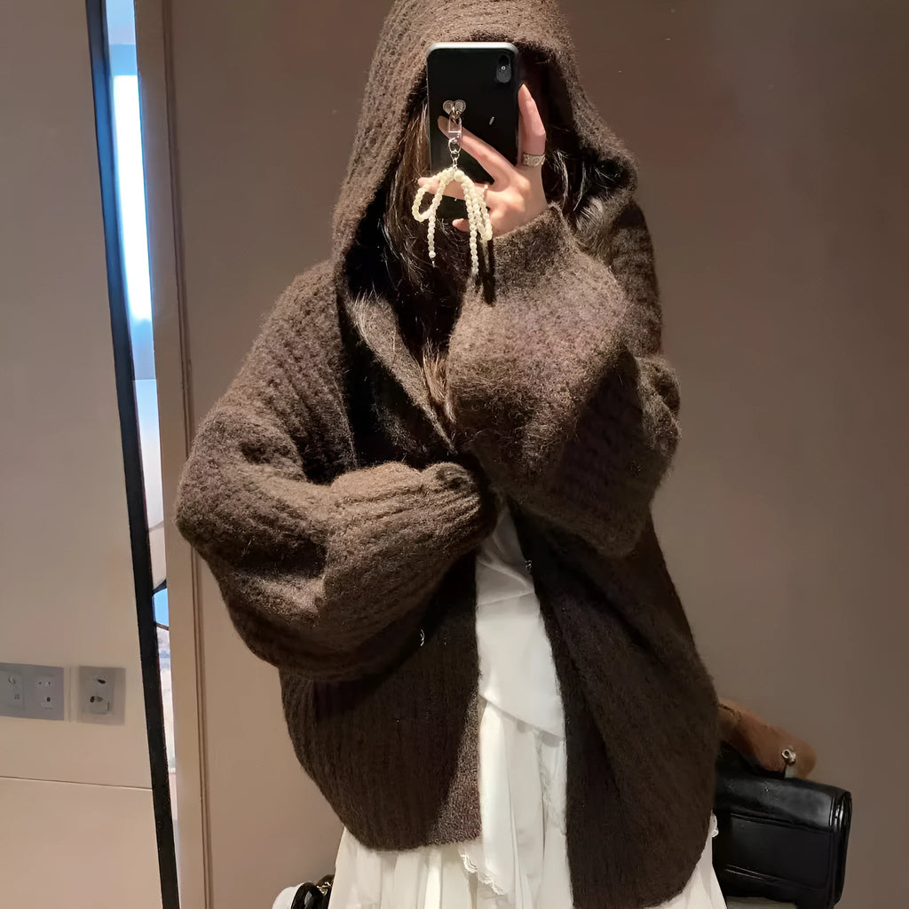 Brown women's hooded sweater cardigan with thick knit and loose fit on a hanger.