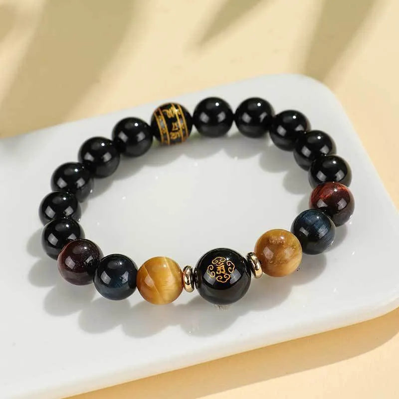 Handmade black agate bracelet with zodiac animal charms and gold tiger eye beads on wrist