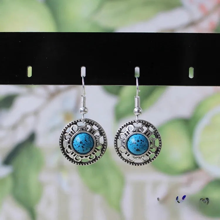 Handmade ethnic Miao silver geometric flower disk earrings with turquoise, in black, blue, or red.