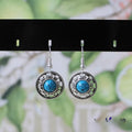 Handmade ethnic Miao silver geometric flower disk earrings with turquoise, in black, blue, or red.