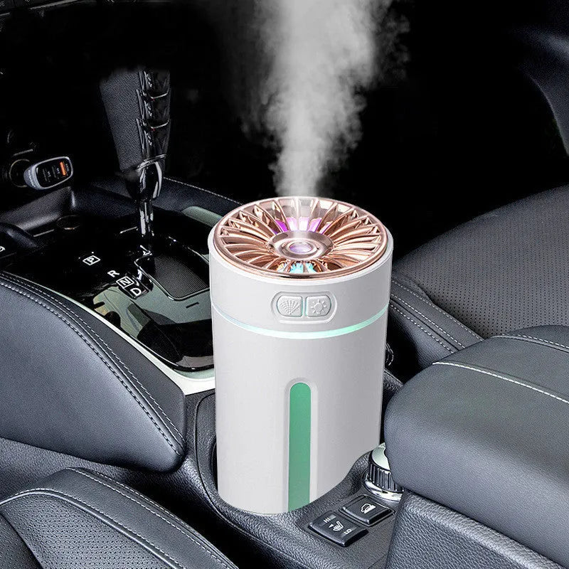 Black portable USB humidifier with colourful lights on a car cup holder.