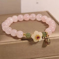 Crystal bracelet with peach blossom charms and polished Hetian jade beads in blessing card colours