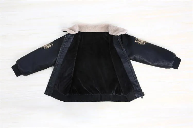 Black PU leather long-sleeved plus velvet jacket for boys with lapel collar and zipper closure, flat lay view