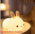 Rabbit silicone pat night light with seven-colour LED on a study desk