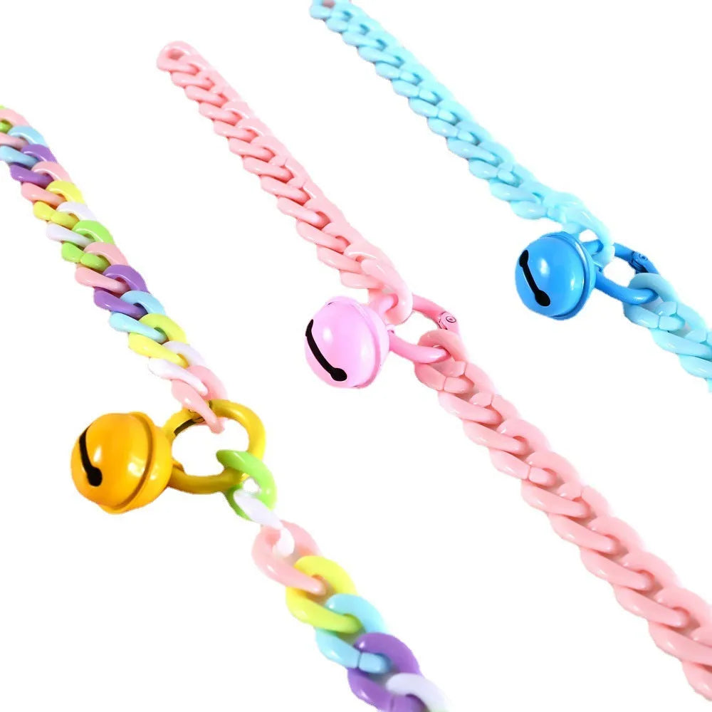 A plastic pet collar in macaron candy colours shown in blue, pink, and mixed variants, with a chain design and S/M size tags.