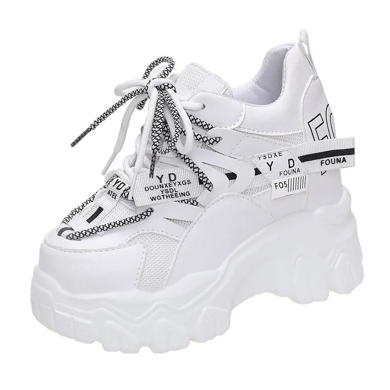 White women's platform sports shoes with mesh upper, cross strap, and a thick rubber sole.