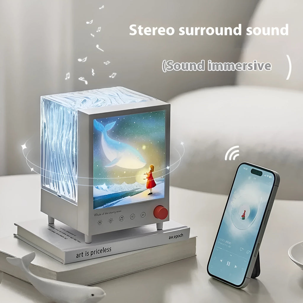 Aurora Treasure Box Star Sea Whale atmosphere projection lamp with Bluetooth speaker on a table.