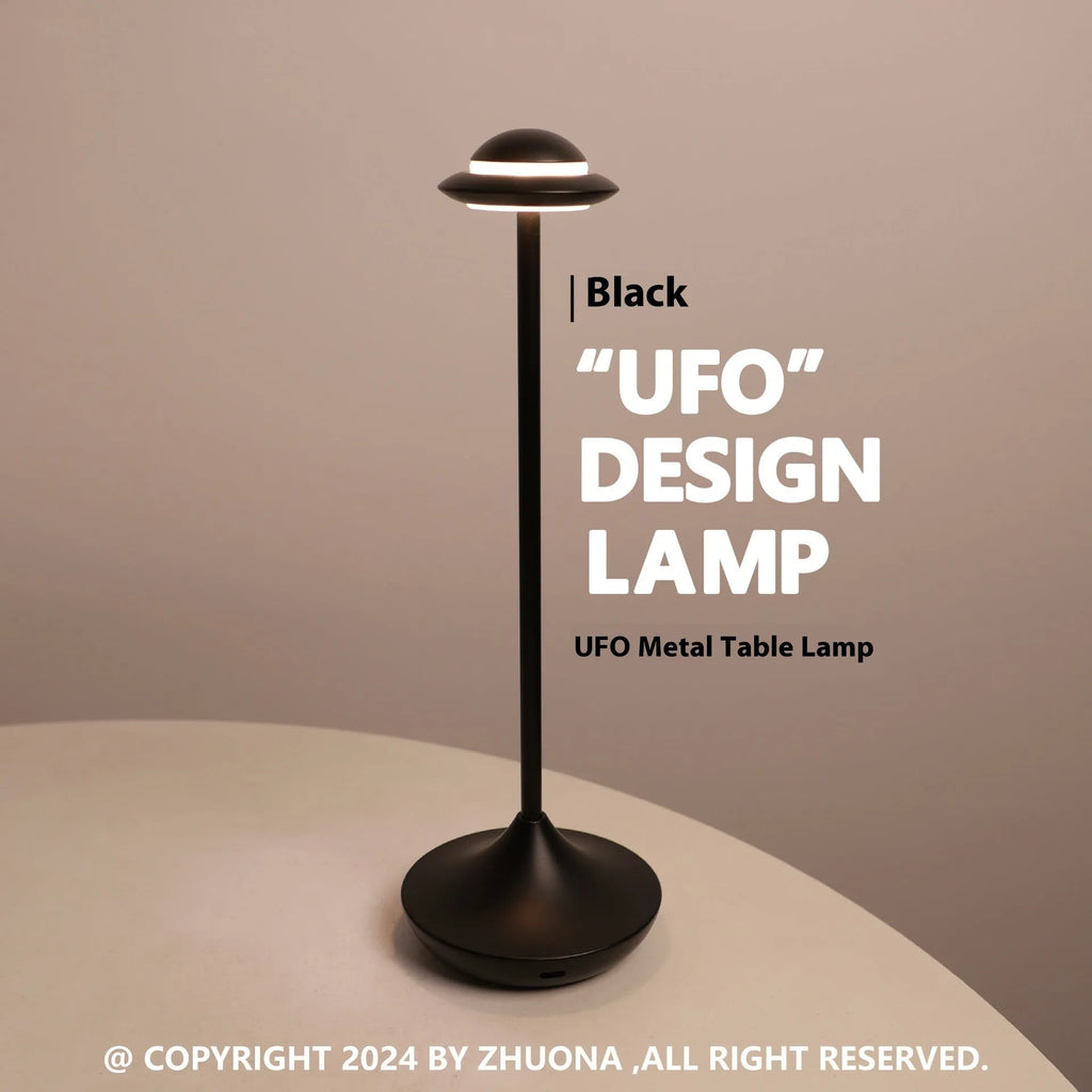 Metallic UFO-shaped rechargeable desk lamp with touch base in black, gold, or grey colour.