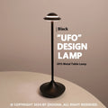 Metallic UFO-shaped rechargeable desk lamp with touch base in black, gold, or grey colour.