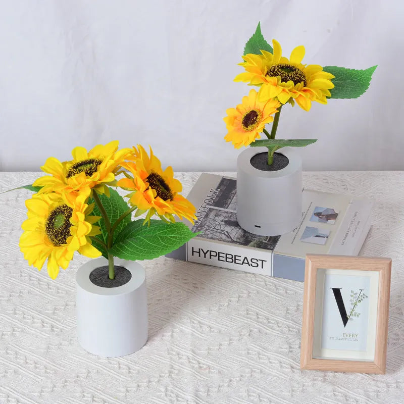 Rechargeable sunflower LED night light with artificial flower design on table