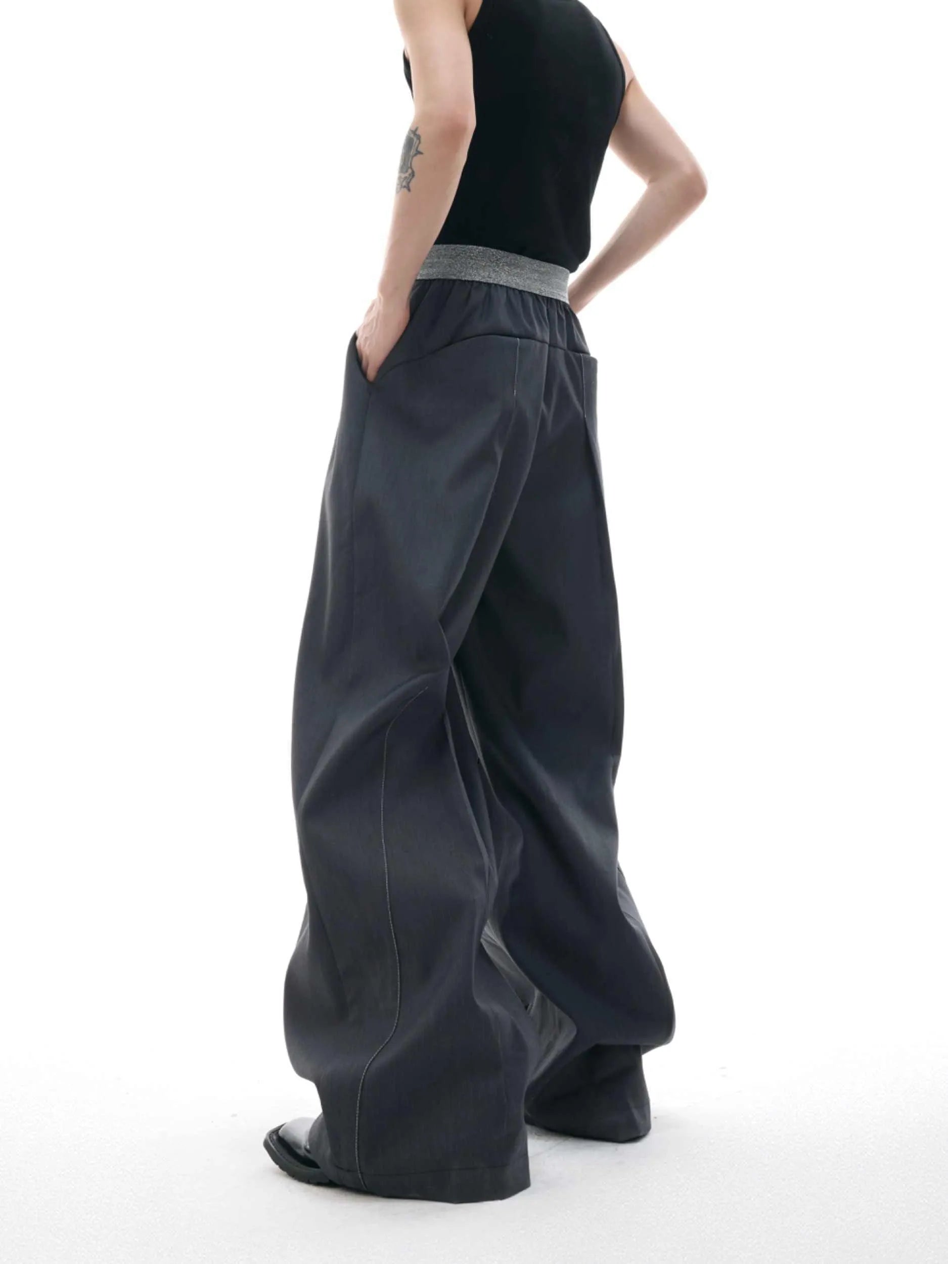 A pair of high-waisted straight-leg casual trousers in grey with a button fly front.