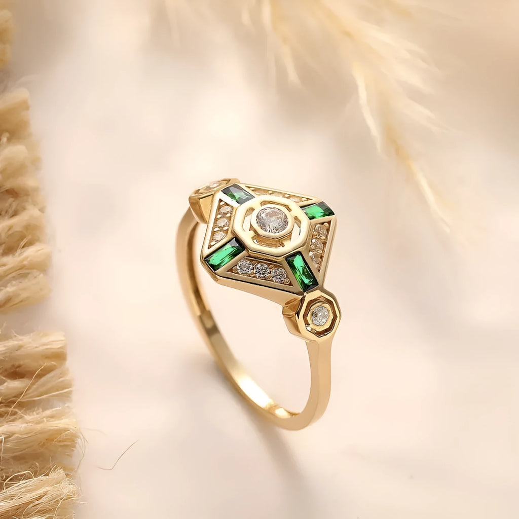 Square geometric emerald diamond ring for women with a green zircon stone on a finger.