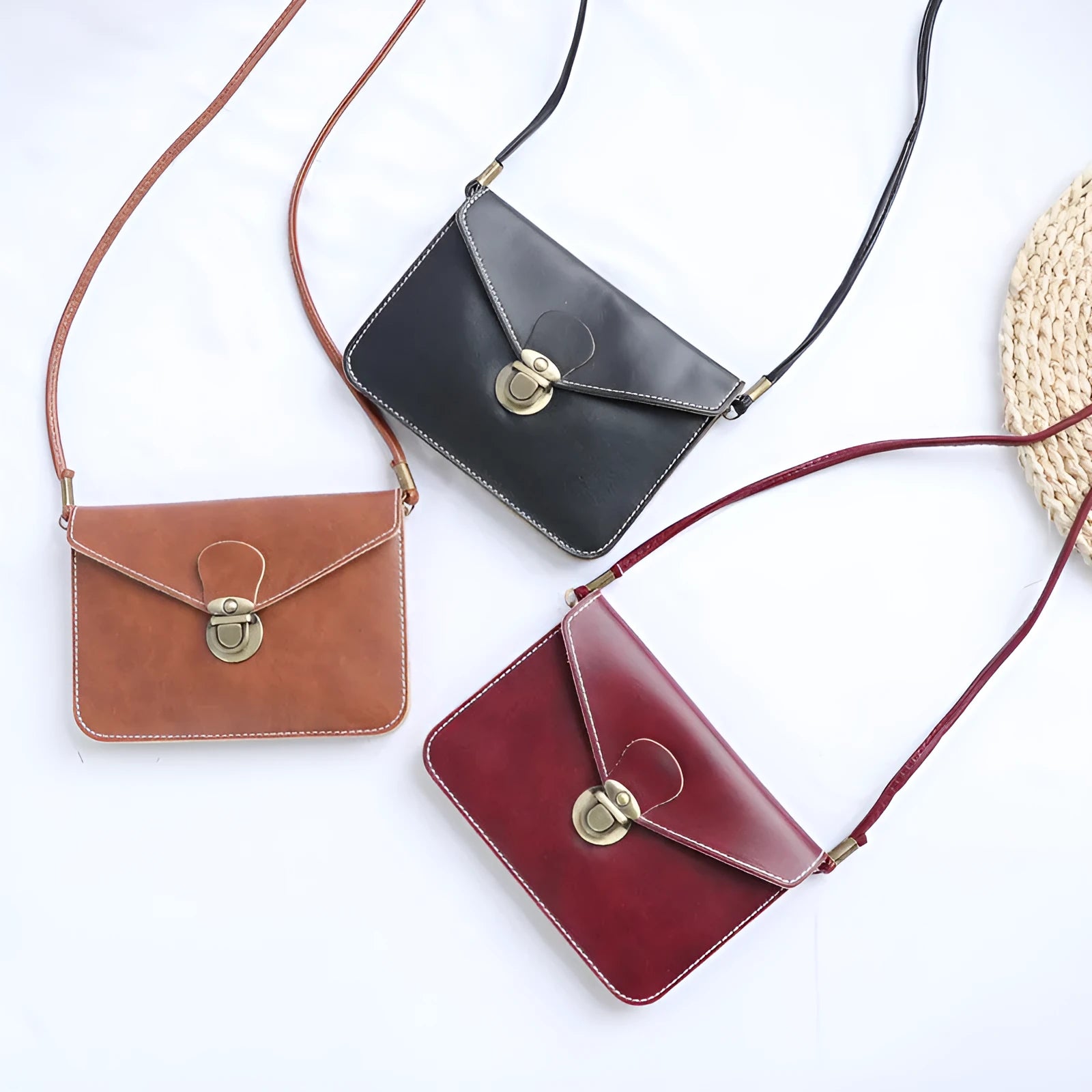 Soft surface PU messenger bag in wine red with a flap closure and metal lock detail.