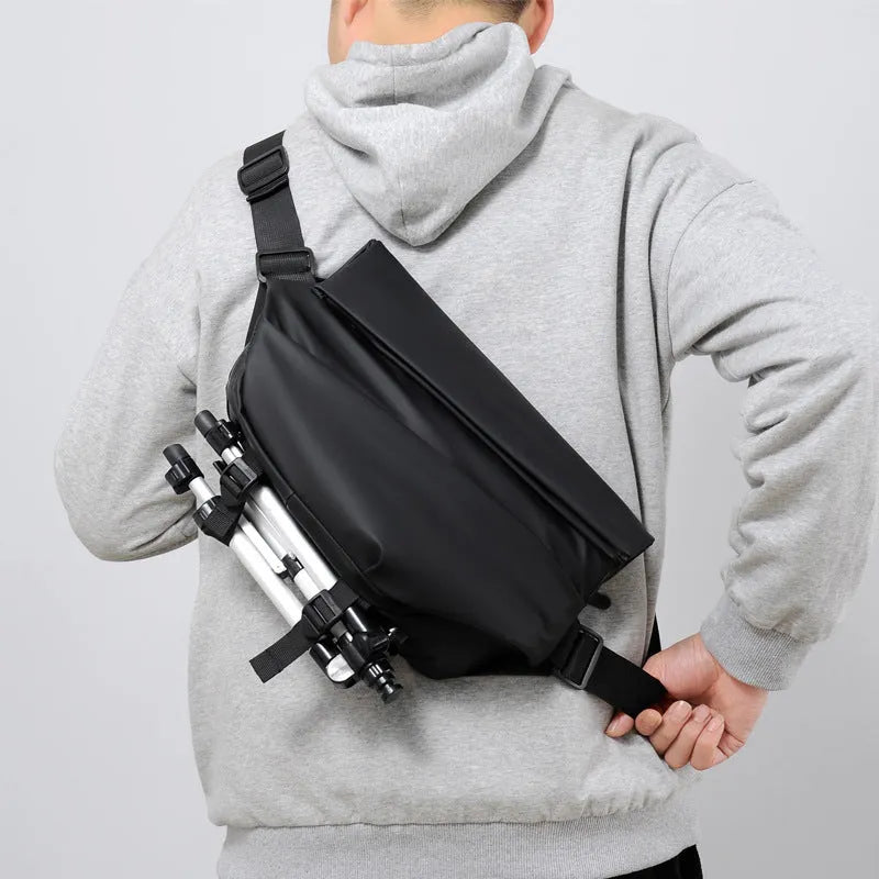 A grey medium-sized horizontal square PU crossbody bag for men, showing the shoulder strap and front zipper.