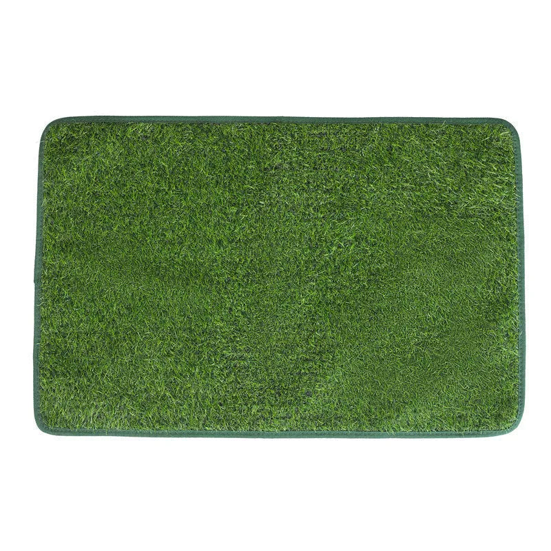 Green washable dog grass pee mat with realistic lawn texture on a patio.