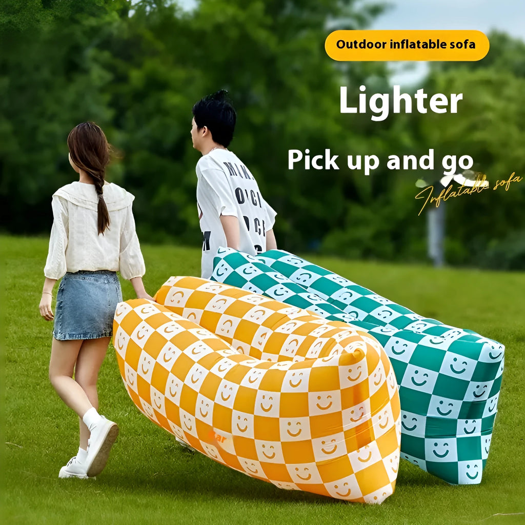 Inflatable portable sofa in a colourful design, shown folded to its 36cm by 27cm size and in use outdoors.
