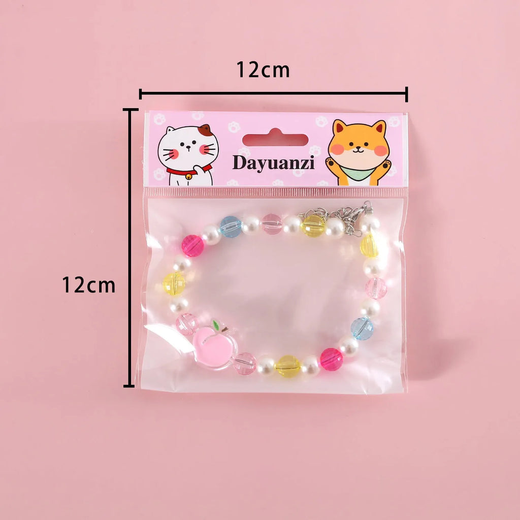 Colourful plastic bead cat necklace showing small flower, rainbow, and peach pattern options with adjustable sizing