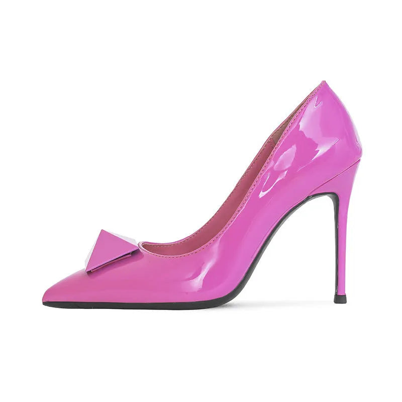 Pink women's patent leather pointed toe stiletto high heels with a buckle strap on a low-top.